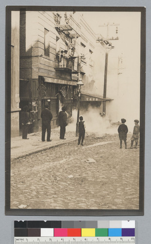 [street scene: back view of men and boys]