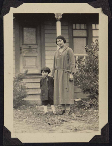 Woman and child standing outside