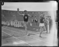 Les Heilman breaks the U.S.C. mile record while Ralph Shawhan trails behind during a dual track meet versus Occidental, Los Angeles, 1926