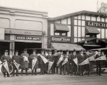 Men in front of Letcher Garage, holding San Jose pennants