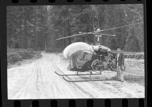 Flood and storm damage, Gordon Bender and helicopter used to investigate 1955 flood damage
