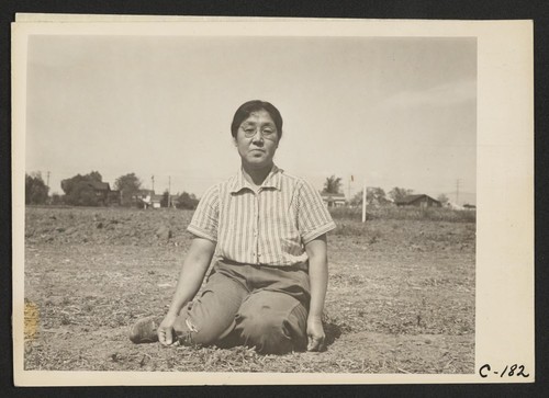 Mrs. Ryohitsu Shibuya, wife of successful chrysanthemum grower, pictured on their farm in Santa Clara County, before evacuation. Horticulturists and