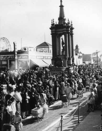 Crowd watches baby doll parade