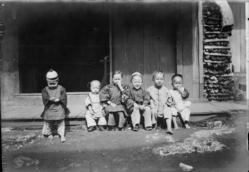 Chinese Children sitting on boardwalk, Monterey. [transparency]