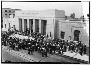 Crowd gathered to listen to a speaker in front of the United States Post Office Hollywood Station