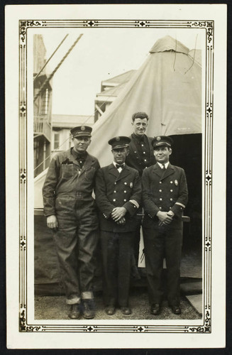 Four unidentified personnel in front of tents set up after the 1933 earthquake