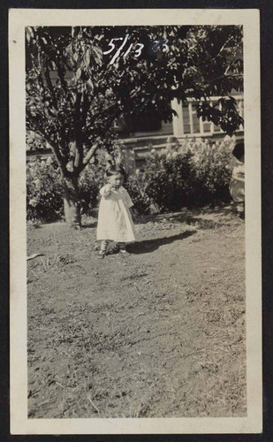 Young girl in front yard