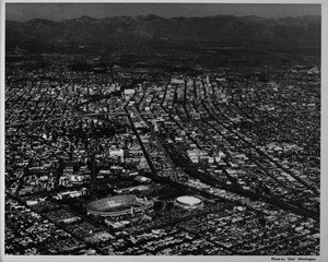 Late afternoon aerial photo facing northeast over Exposition Park looking into Downtown Los Angeles