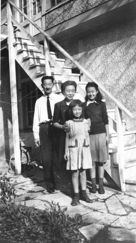 Ishii family standing next to a white wooden staircase