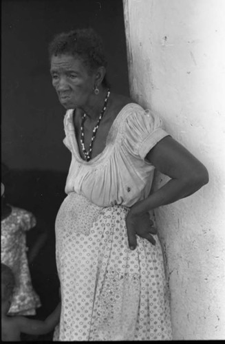 A woman stands by a doorway, San Basilio de Palenque, 1975