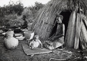 A family in front of its hut