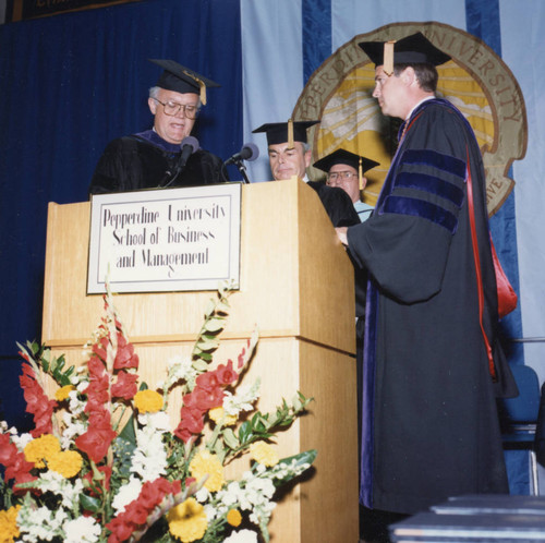 Russel Ray and President Davenport awarding an honorary doctorate to Robert Hood, assisted by Vice Chancellor Hornbaker