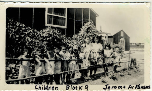 Children of Block 9 standing alongside barracks of Jerome Relocation Center