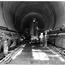 Workers lay concrete in the number two diversion tunnel at the Oroville Dam