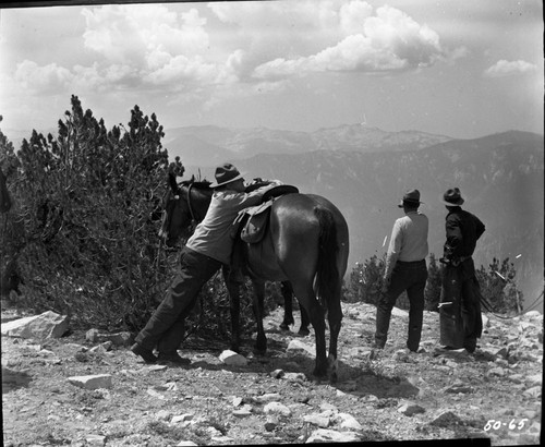NPS Individuals, E.T. Scoyen expressing fatigue on Kennedy Pass, with Irv Kerr and Bruce Black (right). Park Superintendents