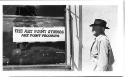 Charles Myers in front of building with sign "The Art Point Studios Art Point Products"