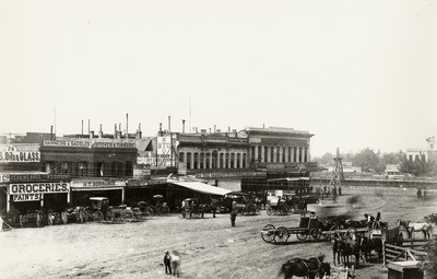 Stockton - Streets - circa 1880s: Hunter St. Perkins Bros. and H.S. Sargent Groceries, H.T. Dorrance Harness, Mutual Trade Union, Post Office