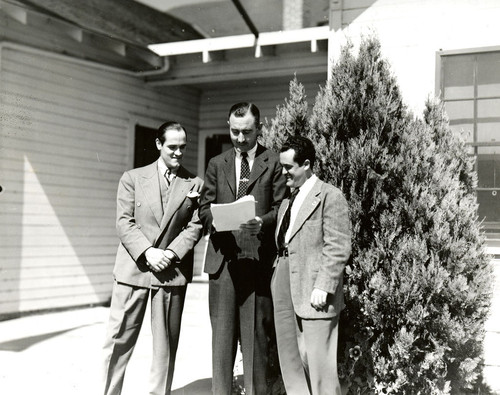 Three men standing outside the Roberts Union Farm Center, [San Joaquin County]