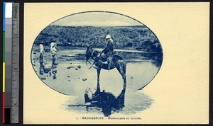 Missionary on horseback in shallow water, Madagascar, ca.1920-1940