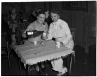 Mrs. Harry E. Willis pouring a beverage for Mrs. Howard M. Jay during a women's club picnic meeting at the home of Mrs. Jay, Los Angeles, July 10, 1939