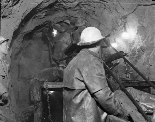 Miners at work drilling the tunnel
