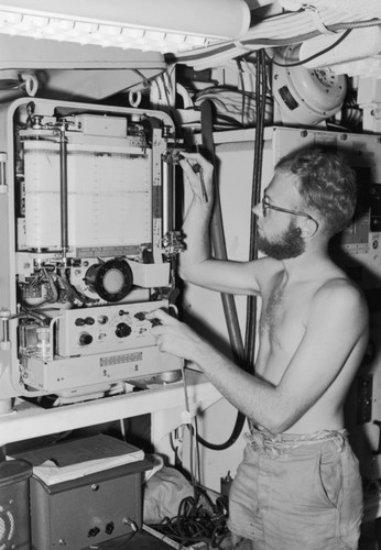 Alan Churchill Jones at the fathometer, a sonar depth finder, aboard R/V Spencer F. Baird