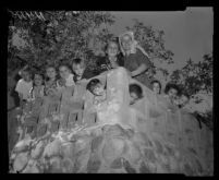Children who survived the bombing of the headquarters of the Fountain of the World sect pose with an adult member in the ruins of the building. D. 1958