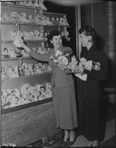 Two ladies with Christmas doll display