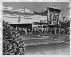 Crowd walking along sidewalk in 100 block of N. Petaluma. Blvd, Petaluma, California, 1972
