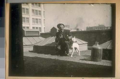 Engineer Frank Crockett, S.F.F. [San Francisco Fire] Dept. and his dog on the roof of the Bulletin, 1919