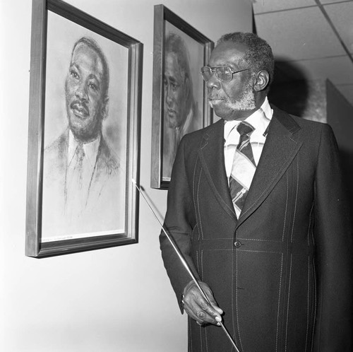 Herman English pointing to a drawing of Dr. Martin Luther King Jr., Los Angeles, 1976