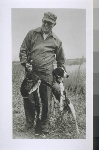 [Earl Warren with dog on hunting trip.]