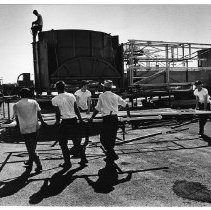 View of the workers assembling "the Roter", the first of the large rides to arrive at the Midway at California State Fair Grounds.This was the last fair held at the old fair grounds