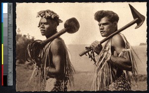 Indigenous men carrying large clubs, New Caledonia, ca.1900-1930