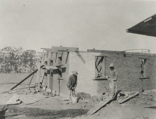 Building adobe house for farm workers
