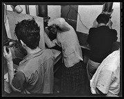 Photography students working in darkroom, California Labor School