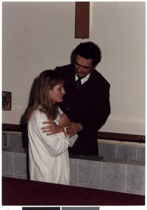 Mihael Kuzmič baptizing a woman