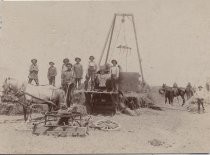 Hay baler with farmworkers