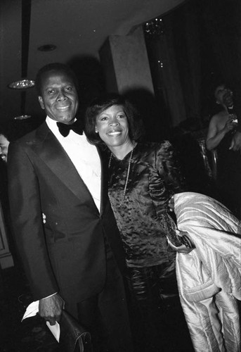 Sidney Poitier posing with Roxie Roker at a Neighbors of Watts benefit, Los Angeles, 1982