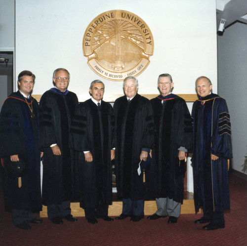 President Davenport, Russell Ray, Robert Hood, Ross Blakely, Chancellor Runnels, and Dean Wilburn beneath the Pepperdine University seal