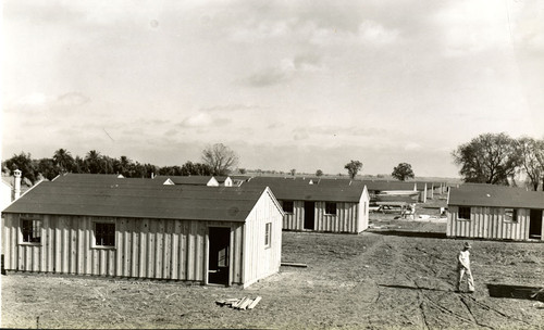 One man walking among the labor camp buildings at Spreckels Sugar Company, Woodland California