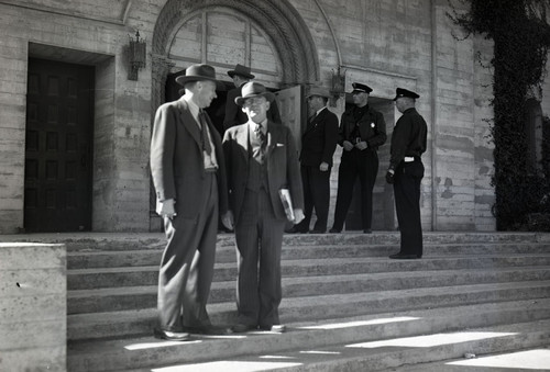 Government officials standing in front of church with police escort