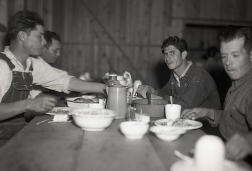 Four Mexican workers eating in dining hall