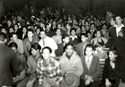 Mexican workers seated in an assembly room