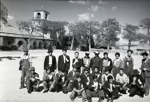 Group of Mexican workers with church in background