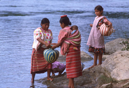 Guatemalan refugees collect water at a river, Chajul, ca. 1983