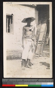 Shirtless man wearing a straw hat outdoors, Jiangsu, China, ca.1905-1910