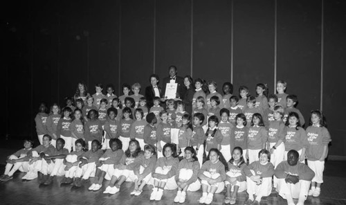 Tom Bradley posing with the Children of the World Chorus, Los Angeles, 1985
