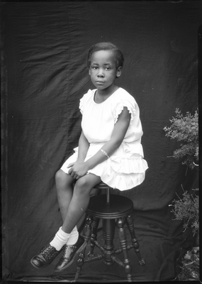 Portrait of girl sitting on stool