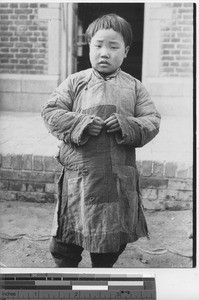 A boy in patched clothing at Fushun, China, 1936